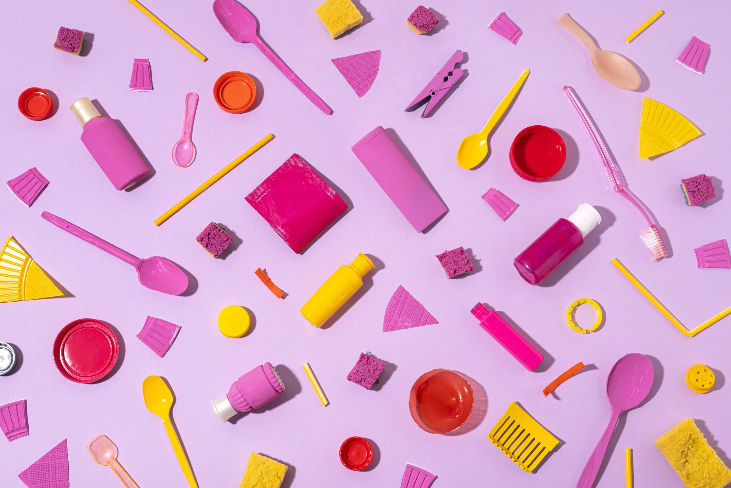 Flat-lay of minimal, recyclable consumer product packaging arranged on a pale background
