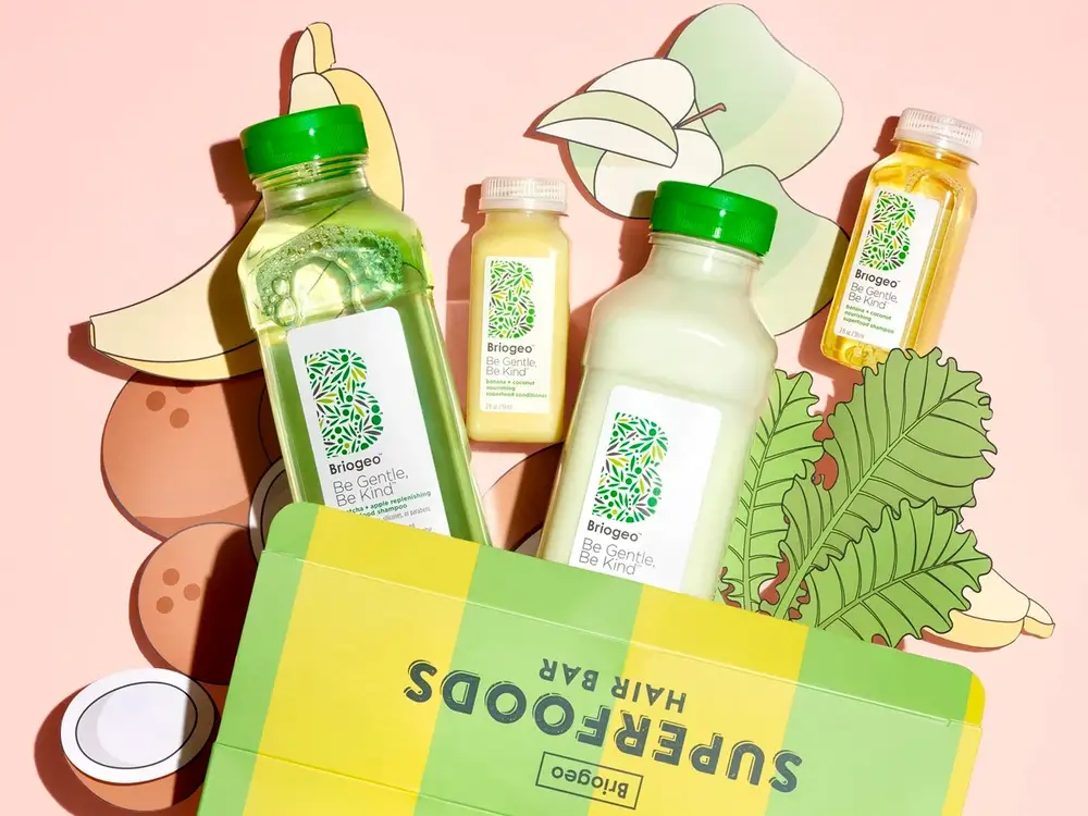 Haircare products styled on a neutral backdrop